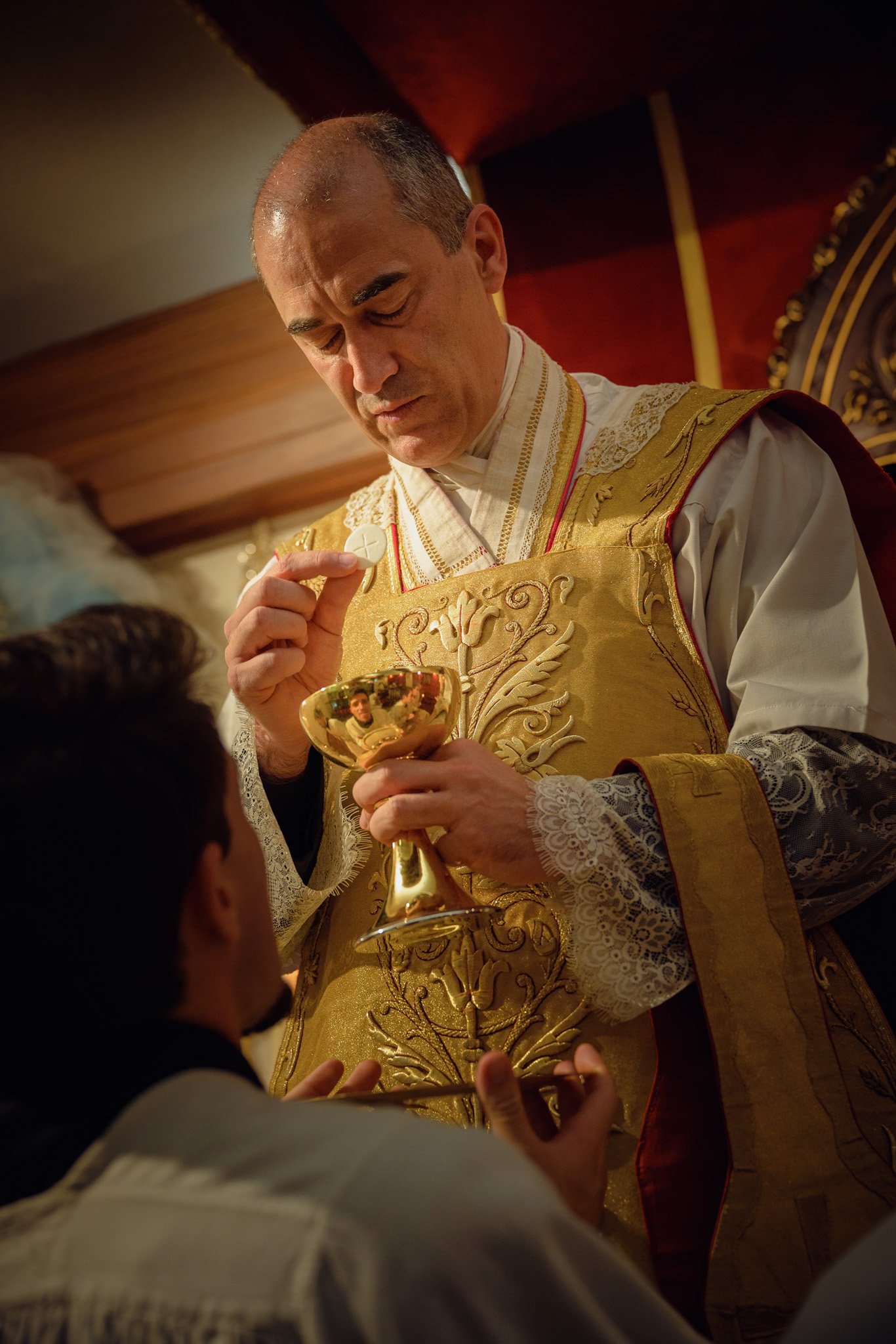 The Paschal candle handed to parents and godparents