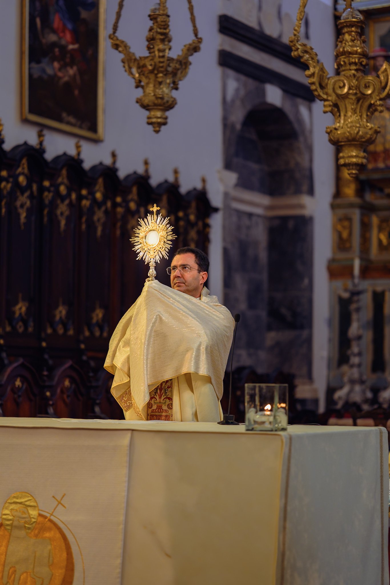 A child with folded hands during the holy service