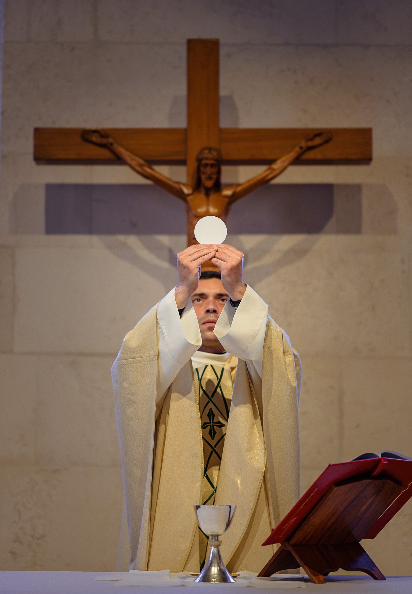 The priest offering the solemn blessing to mother and child